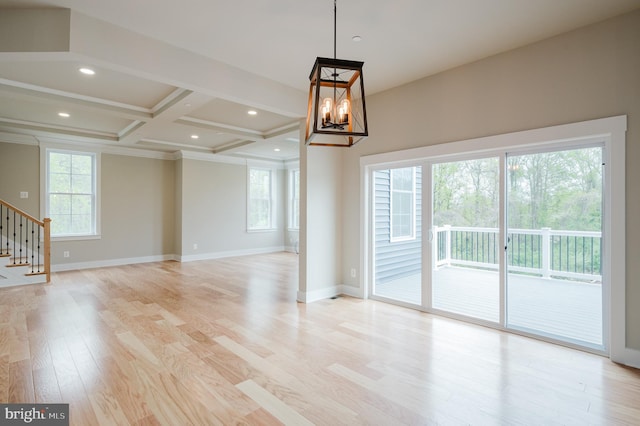 interior space with coffered ceiling, a wealth of natural light, light hardwood / wood-style flooring, and beamed ceiling