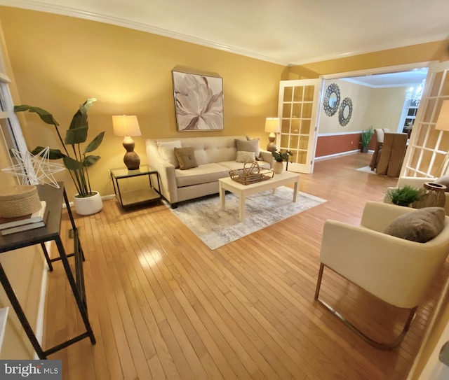 living room featuring ornamental molding and light wood-type flooring