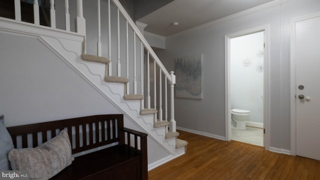 entryway featuring hardwood / wood-style flooring and crown molding