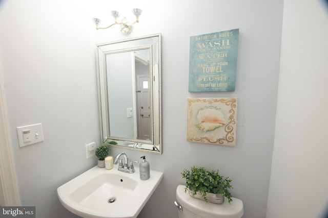 bathroom featuring sink and toilet