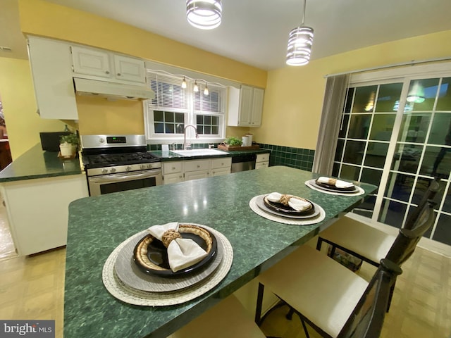 kitchen featuring kitchen peninsula, white cabinetry, sink, and appliances with stainless steel finishes