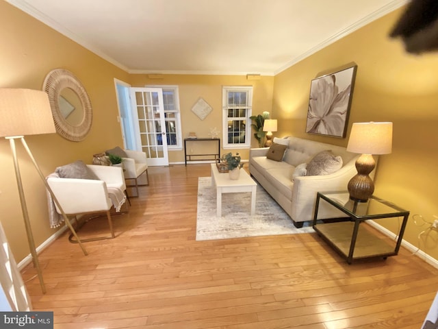 living room featuring light wood-type flooring and crown molding