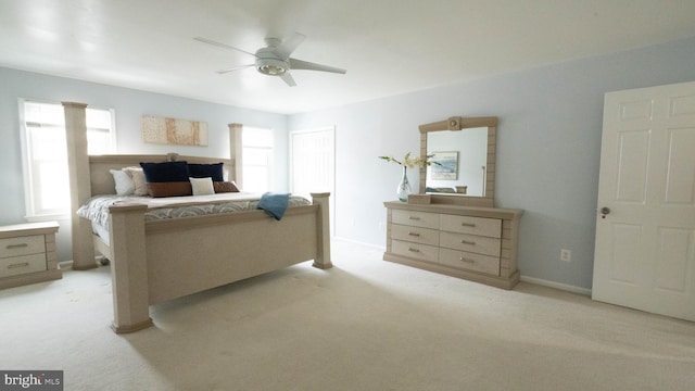 bedroom featuring ceiling fan and light carpet