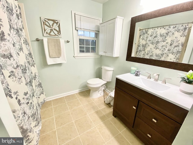 bathroom featuring toilet, vanity, tile patterned floors, and curtained shower