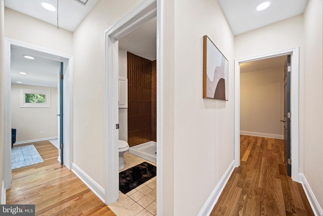 hallway with light hardwood / wood-style flooring