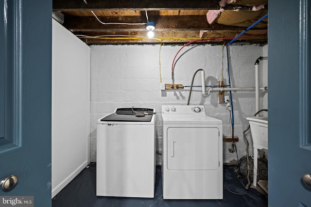 washroom featuring washer and clothes dryer and sink