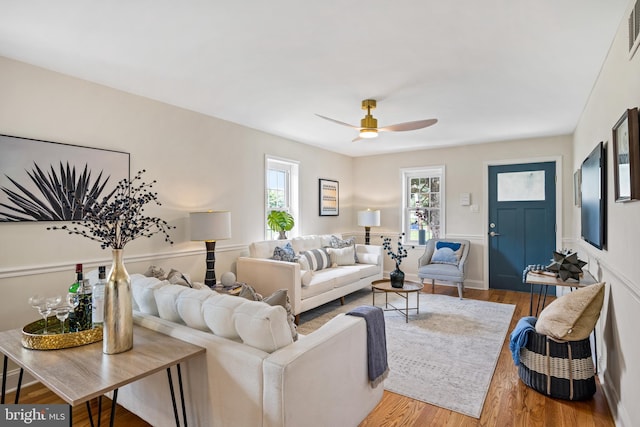 living room featuring ceiling fan and hardwood / wood-style flooring