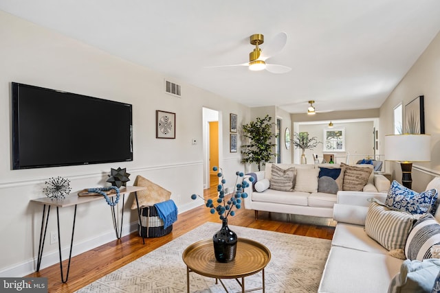 living room with hardwood / wood-style floors and ceiling fan