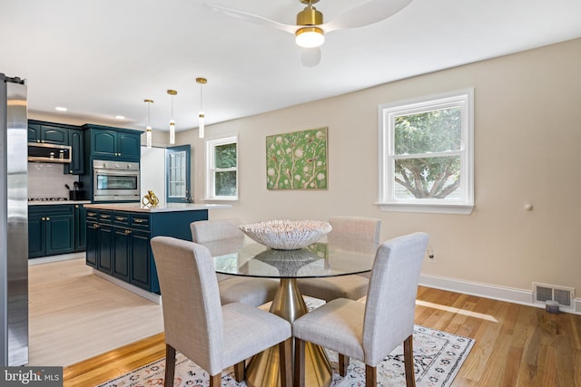 dining room featuring ceiling fan and light hardwood / wood-style floors