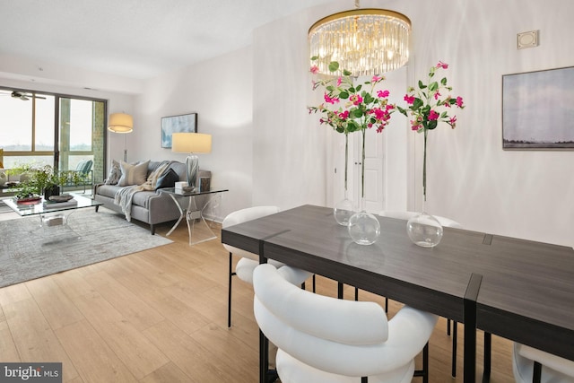 dining room featuring an inviting chandelier and light wood-type flooring