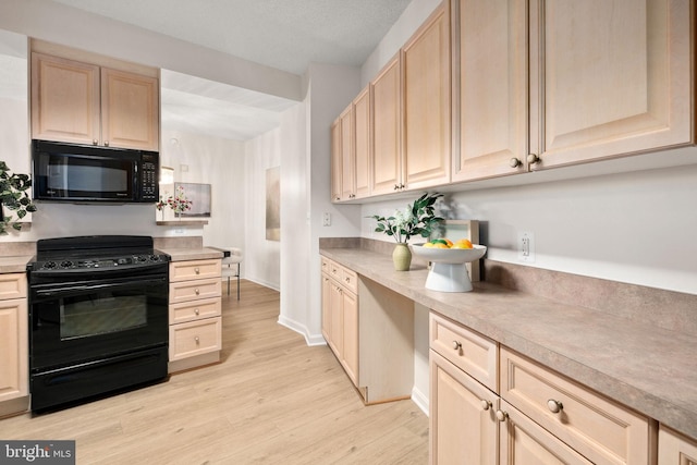 kitchen with black appliances, light hardwood / wood-style floors, and light brown cabinets