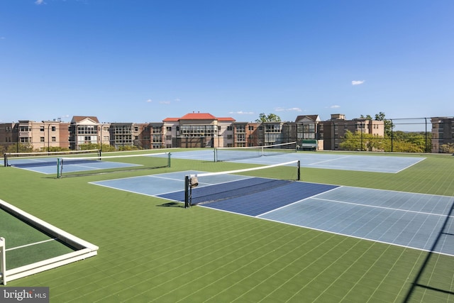 view of tennis court with basketball hoop