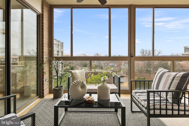 sunroom / solarium with a wealth of natural light and ceiling fan