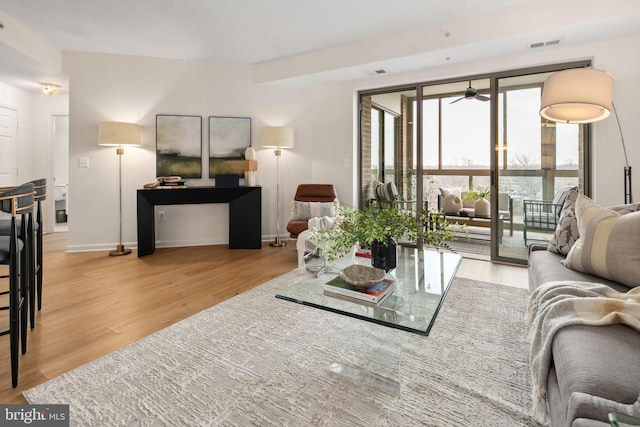 living room with hardwood / wood-style flooring and ceiling fan