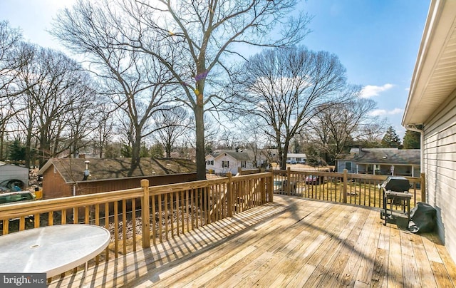 wooden terrace featuring area for grilling