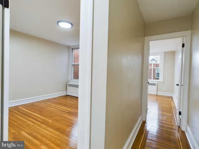 hall with wood-type flooring