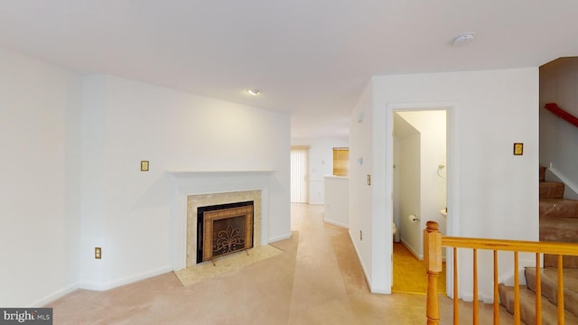 carpeted living room featuring a premium fireplace