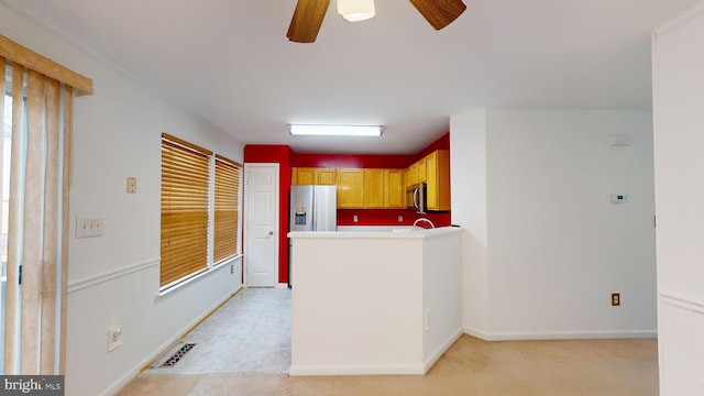 kitchen with ceiling fan, a healthy amount of sunlight, light carpet, and appliances with stainless steel finishes