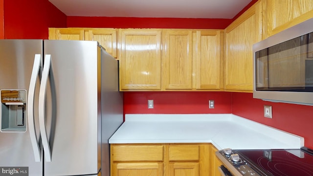 kitchen featuring light brown cabinets and stainless steel appliances