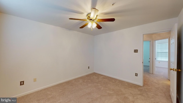 empty room with light colored carpet and ceiling fan