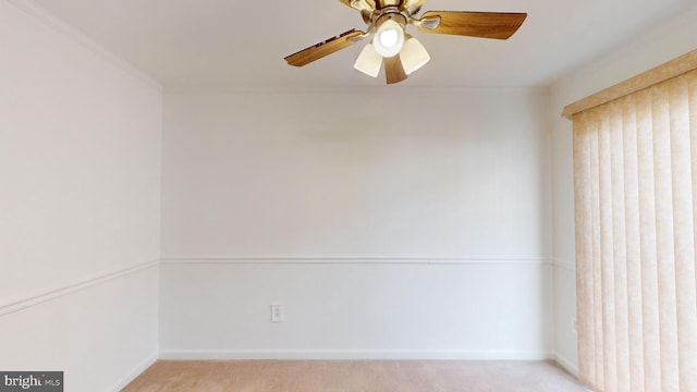 carpeted empty room with ceiling fan and ornamental molding