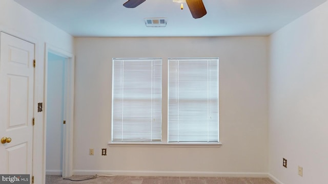 spare room featuring ceiling fan and light carpet