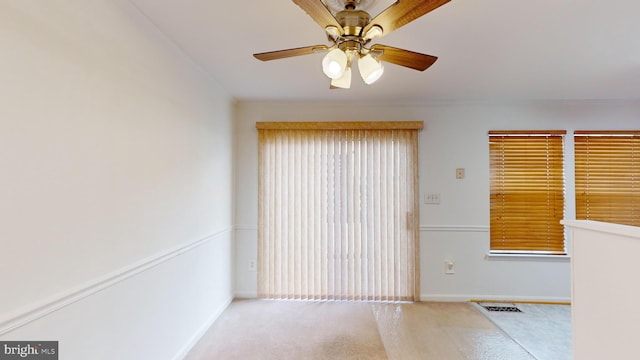 empty room with light colored carpet and ceiling fan