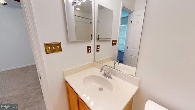 bathroom featuring vanity and toilet