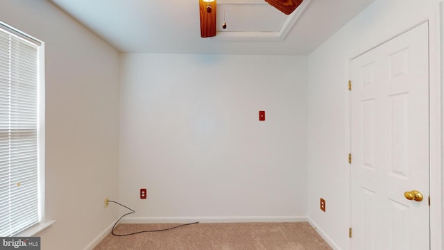 clothes washing area featuring light carpet