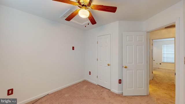 unfurnished bedroom with light colored carpet and ceiling fan