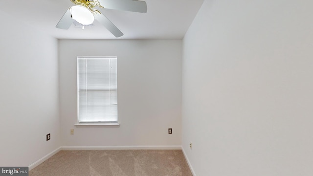 empty room featuring ceiling fan and light colored carpet