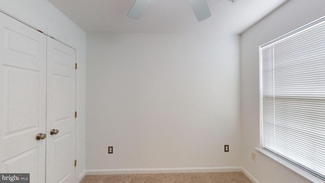 unfurnished bedroom featuring ceiling fan, light colored carpet, and a closet