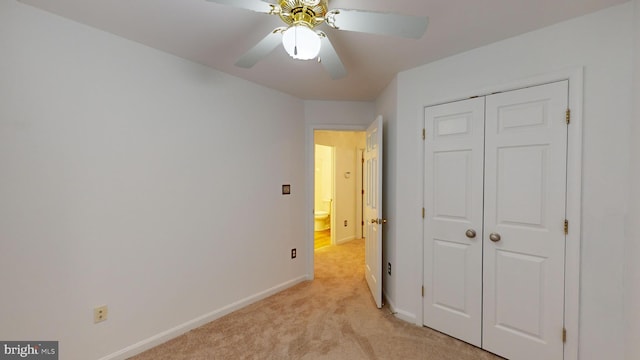 carpeted bedroom featuring a closet and ceiling fan