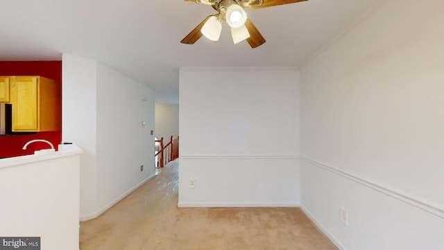 spare room with light carpet and ceiling fan