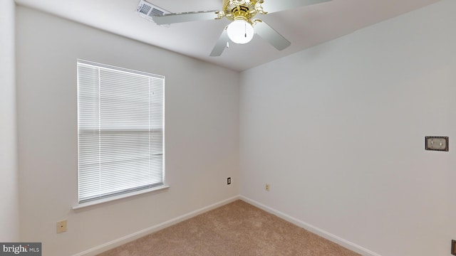 carpeted spare room featuring ceiling fan