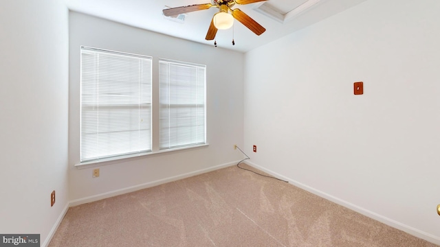 unfurnished room with ceiling fan and light carpet