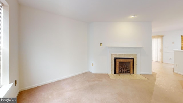 unfurnished living room featuring light carpet