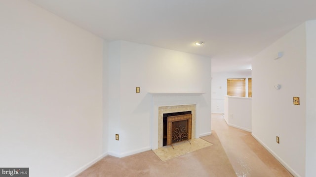 unfurnished living room featuring light carpet