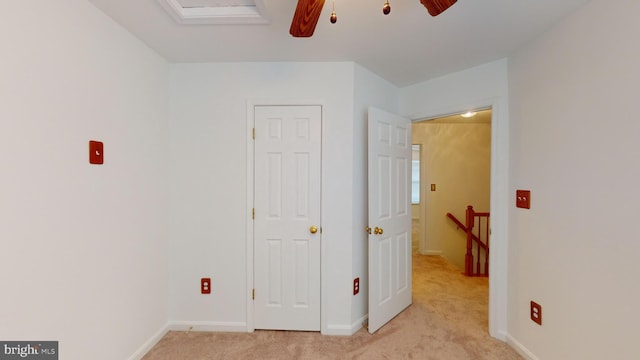 unfurnished bedroom with light carpet and ceiling fan