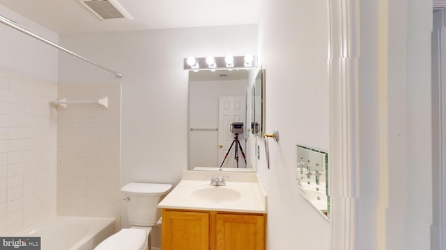 full bathroom with vanity, toilet, and tiled shower / bath combo