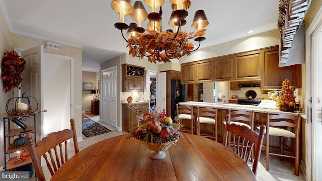 dining room with a notable chandelier and ornamental molding