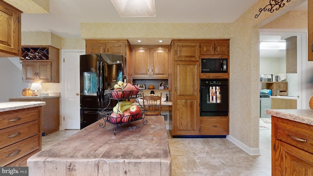 kitchen with a kitchen island and black appliances