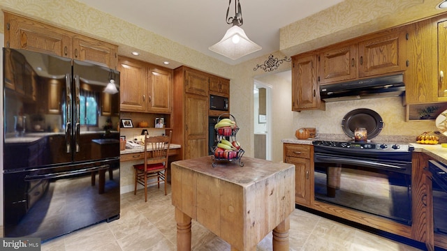 kitchen featuring pendant lighting, tasteful backsplash, black appliances, and a center island