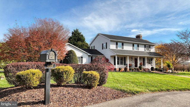 view of front of home with a front yard and a porch