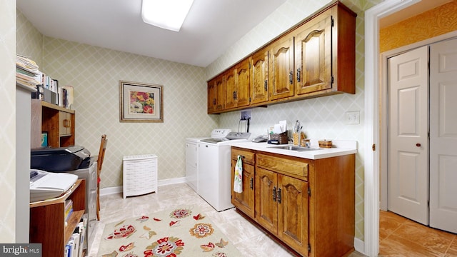 washroom with cabinets, washer and dryer, sink, and light tile patterned floors