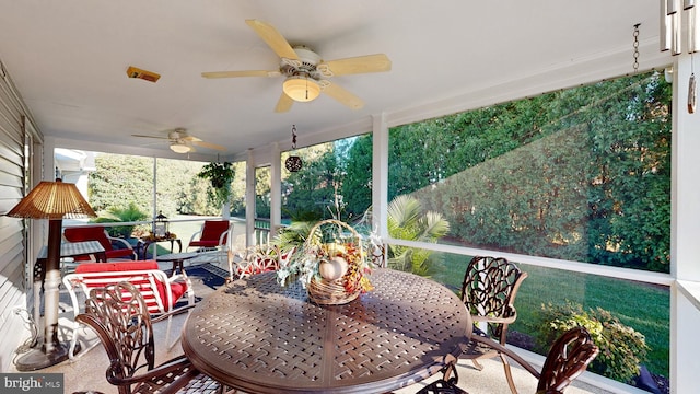 sunroom featuring ceiling fan