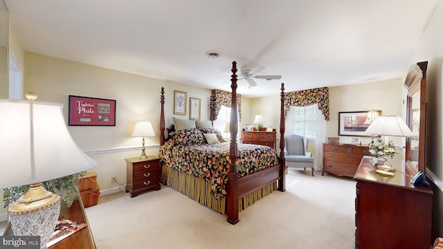 bedroom featuring light colored carpet and ceiling fan