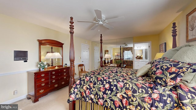 carpeted bedroom featuring connected bathroom and ceiling fan