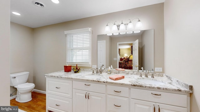 bathroom with vanity, hardwood / wood-style floors, and toilet