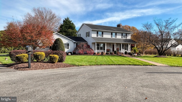 view of front of house featuring a porch and a front yard